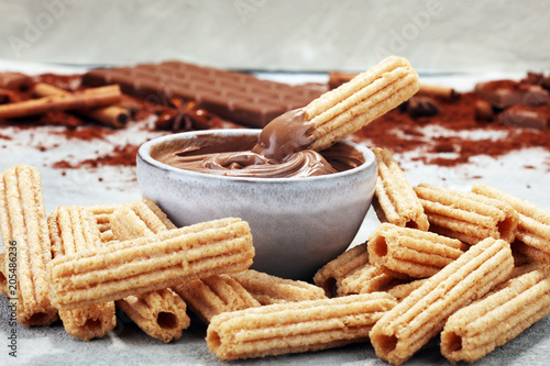 Traditional Spanish dessert churros with sugar and chocolate