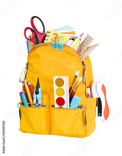 Yellow school backpack with school supplies isolated on white background photo