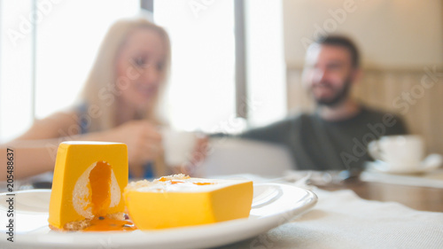 Young couple takes the menu to make an order at the cafe