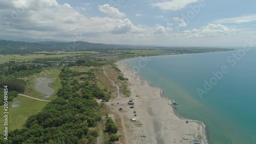 Aerial view of coastline with sandy beach, azure water on the island Luzon, Philippines. Seascape, ocean and beautiful beach. Agoo Damortis National Seashore Park. photo