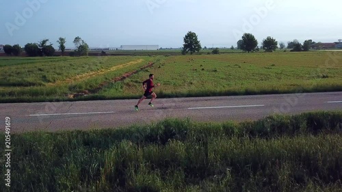 Drone view of a man running in the countryside