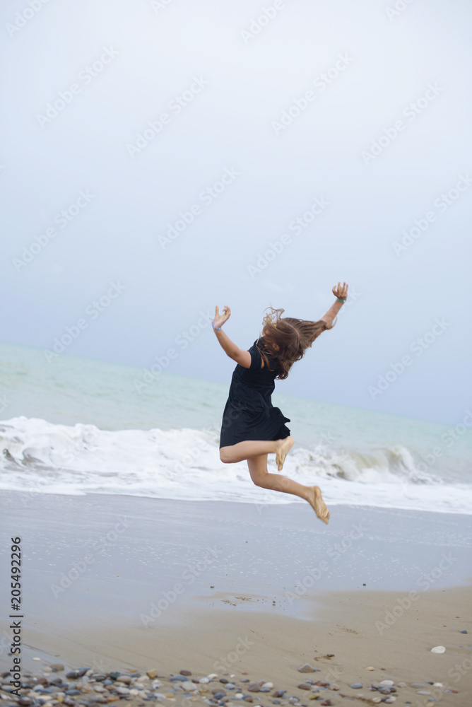 beautiful teen girl near the sea. littered the horizon