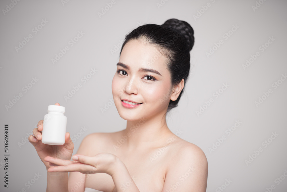 Healthy happy asian woman with pills bottle in hand. Healthy happy asian woman with pills bottle in hand.