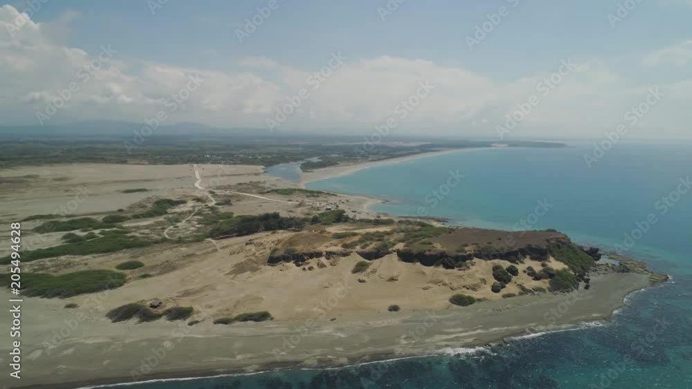Aerial view of seashore with beaches, lagoons and coral reefs. Philippines, Luzon, Ilocos Norte. Coast ocean with turquoise water. Tropical landscape in Asia. Aerial view of seashore with beaches, lagoons and coral reefs. Philippines, Luzon, Ilocos Norte. Coast ocean with turquoise water. Tropical landscape in Asia.