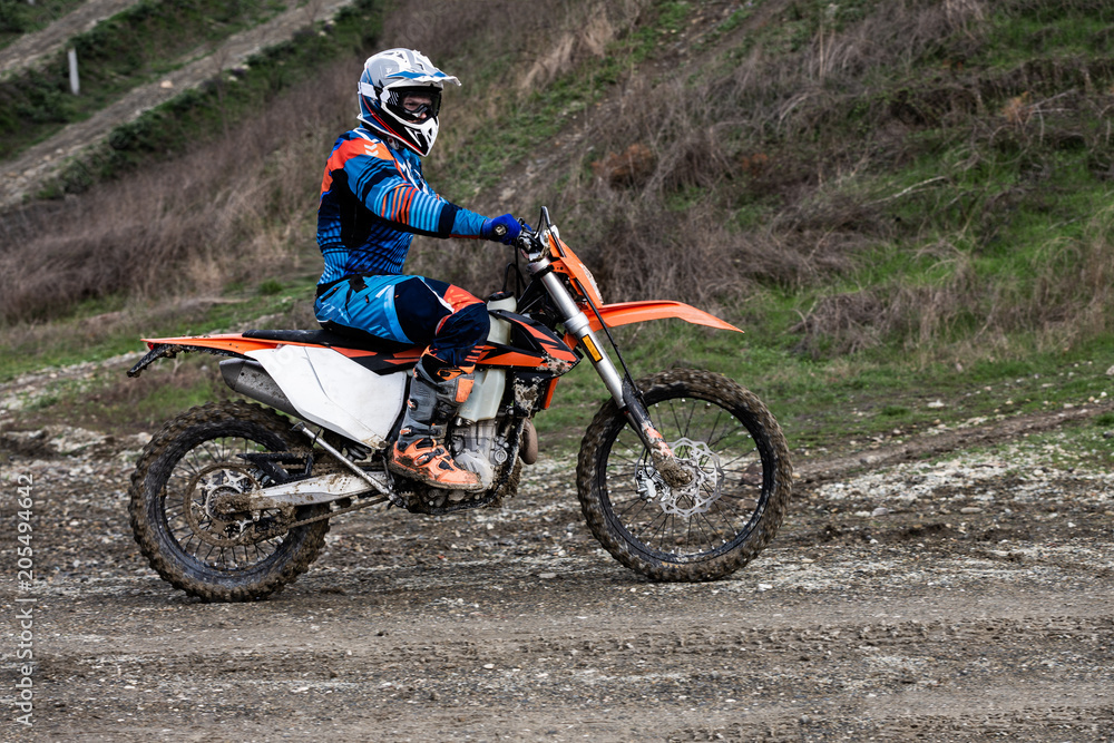 man riding a motocross in a protective suit man riding a motocross in a protective suit