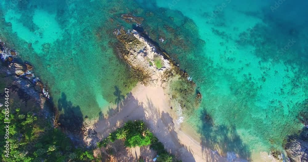 aerial view above blue sea. Nui beach small beach in the middle of Promthep cape and wind turbine in front of beach is Dorn island. Nui beach is the good place for swimming snorkeling and sea canoe aerial view above blue sea. Nui beach small beach in the middle of Promthep cape and wind turbine in front of beach is Dorn island. Nui beach is the good place for swimming snorkeling and sea canoe