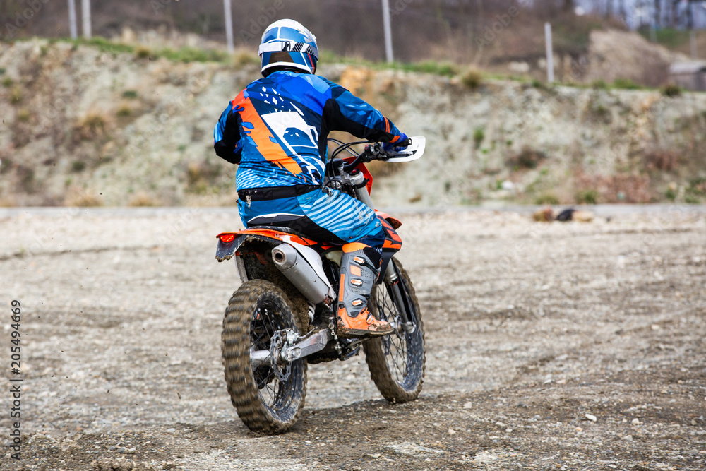 man riding a motocross in a protective suit