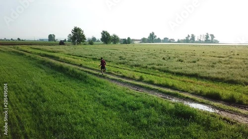 Drone view of a man running in the countryside