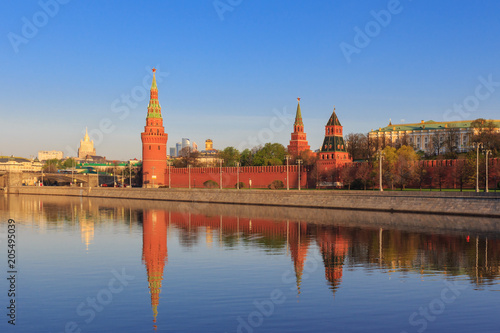 Moscow Kremlin towers with reflection in water of Moskva river on a sunny spring morning