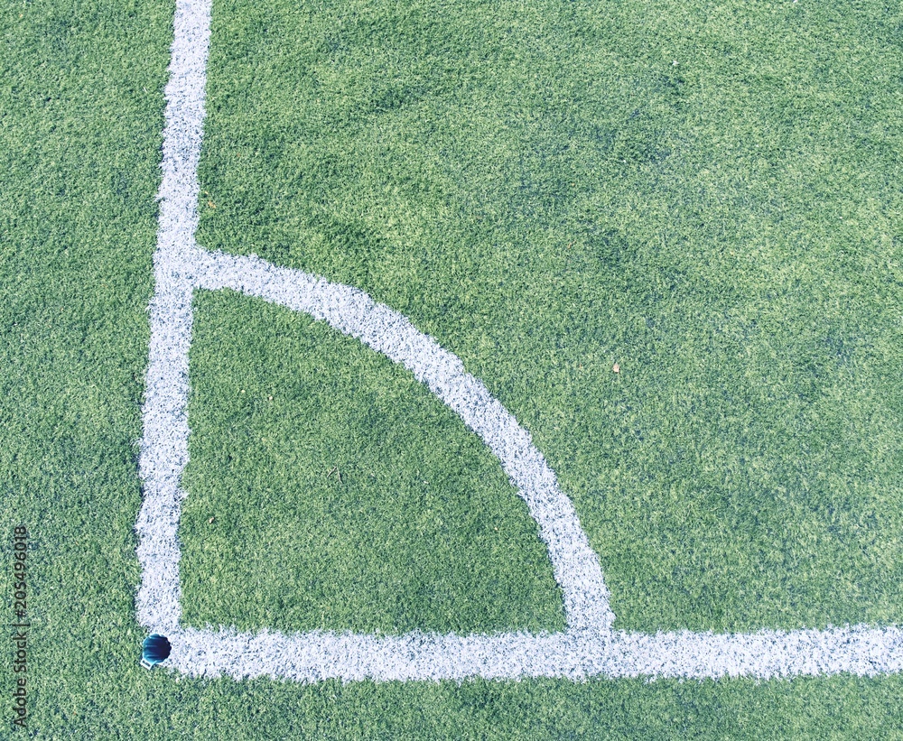 Play field corner, green grass texture of football or soccer field. Marked corner Stock Photo