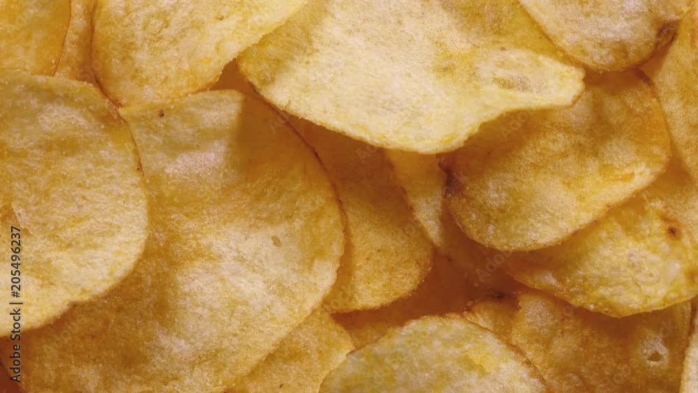 Appetizing potato chips rotating in 4K. Super closeup flat-lay view of popular yummy fast food.
Appetizing potato chips rotating in 4K. Super closeup flat-lay view of popular yummy fast food.