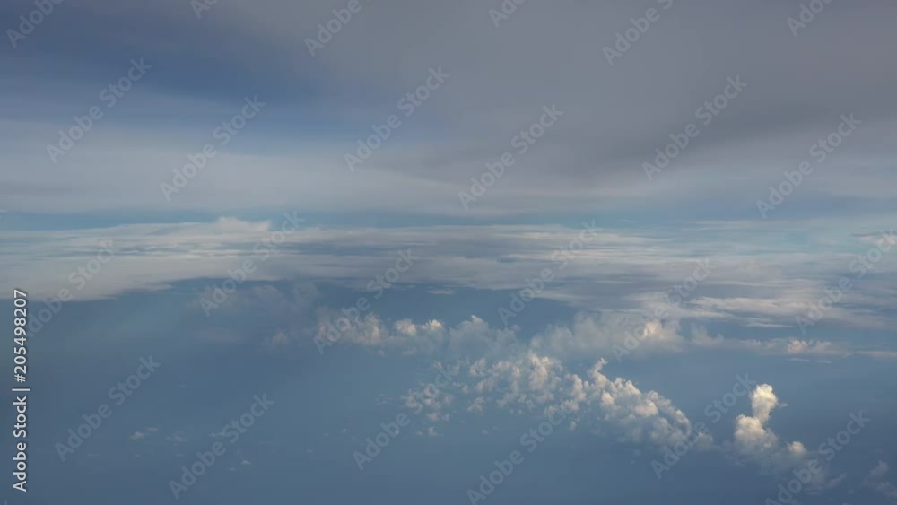 Gorgeous cloudy sky. Beautiful clouds illuminated by soft sunlight floating above land and forming layers. Spectacular skyscape or cloudscape. Picturesque aerial view from window of flying airplane. Gorgeous cloudy sky. Beautiful clouds illuminated by soft sunlight floating above land and forming layers. Spectacular skyscape or cloudscape. Picturesque aerial view from window of flying airplane.