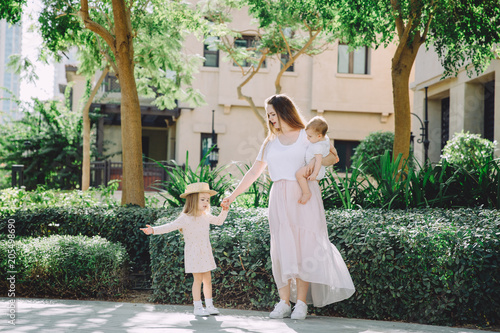Konstfotografi Portrait of happy beautiful mother with her adorable little daughters relaxing i