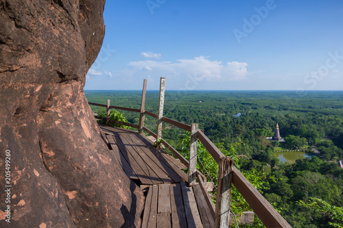 Beautiful scenery of wooden pathway along the cliff with blue sky and wild in the background, Phu Thok, Bueng Kan, Thailand