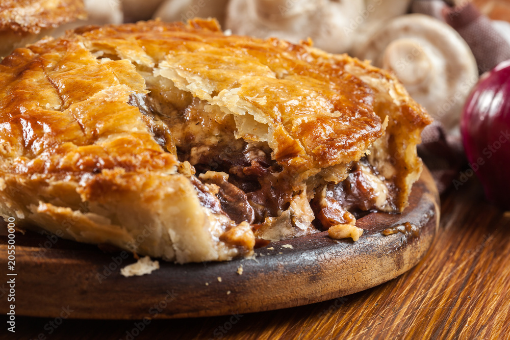 Fresh beef stew pie on a cutting board Fresh beef stew pie on a cutting board