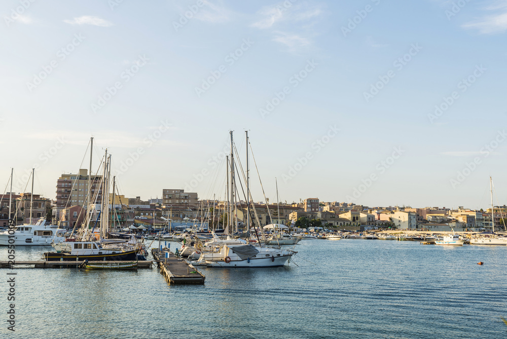Ships, yachts and sailboats docked in Siracusa, Sicily, Italy