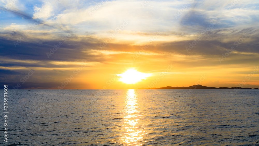 Sunset over island sea or ocean at the evening time with blue sky. Sunset over island sea or ocean at the evening time with blue sky.
