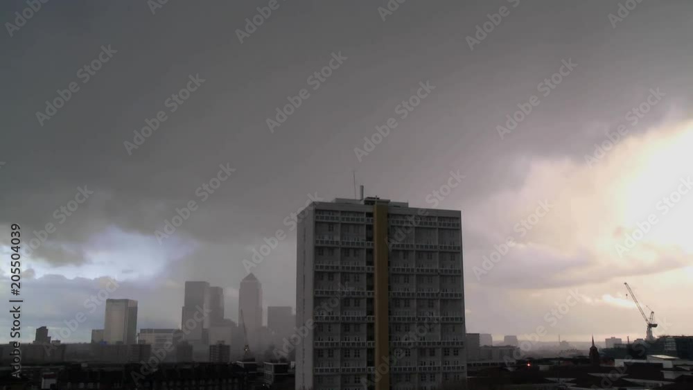 UK April 2012 - Time lapse of a rain shower passing over Canary Wharf and and East London tower block. UK April 2012 - Time lapse of a rain shower passing over Canary Wharf and and East London tower block.