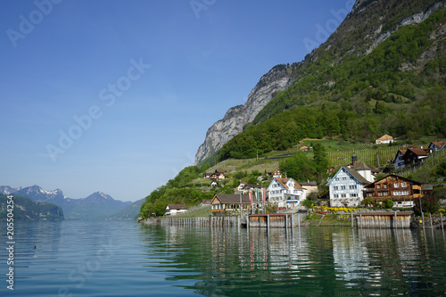Swiss village Quinten on Walensee Lake seen from ferry from Murg. Village is only reachable by boat or foot. Village has warm micro climate and vineyards.