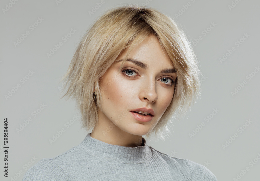 Fototapeta premium Beauty portrait of female face with natural skin isolated on grey