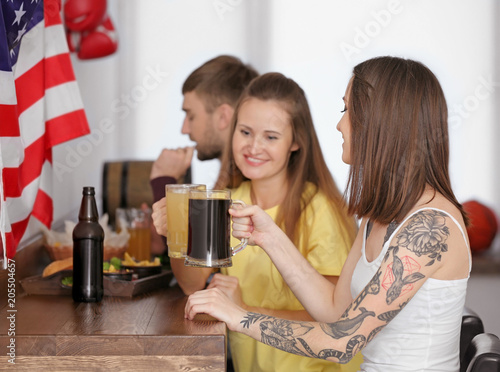Friends with beer in sport bar