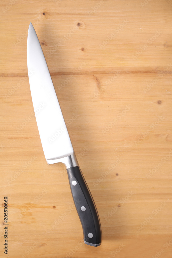 cook knife on a wooden cutting board with space for your text cook knife on a wooden cutting board with space for your text