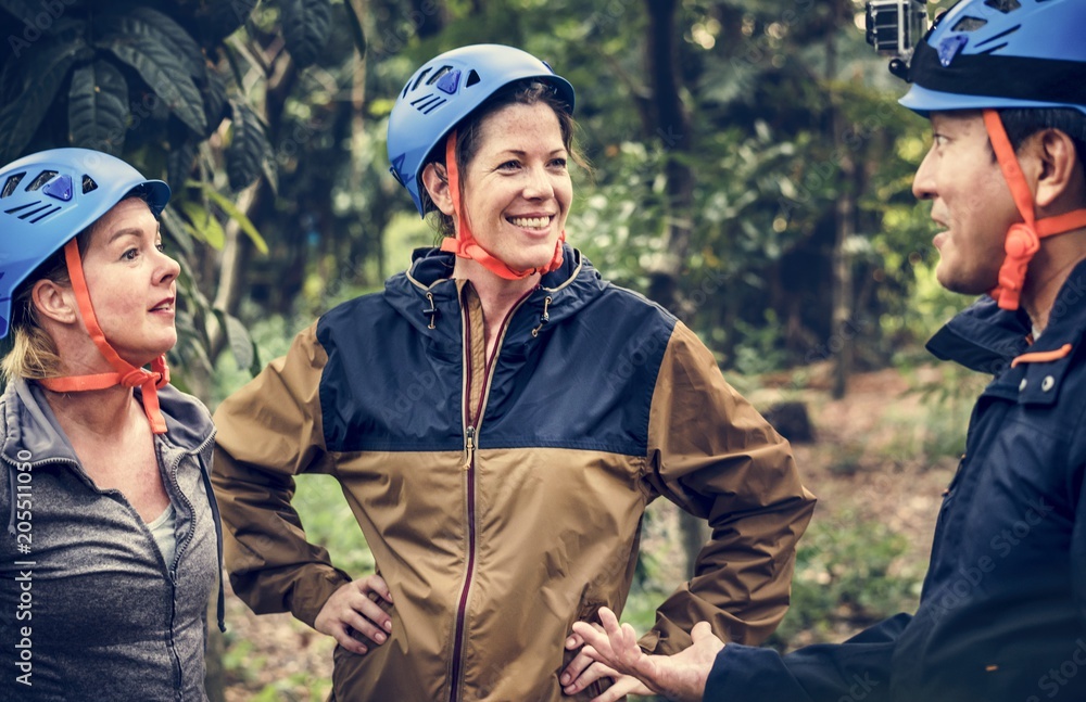 Fototapeta premium Diverse friends trekking in the forest together