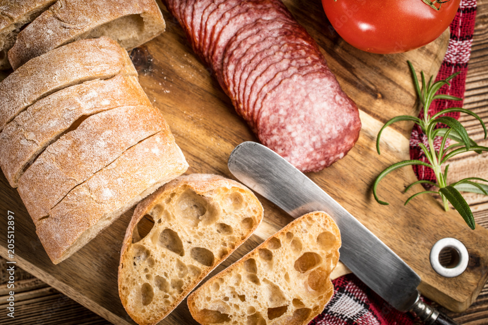 Italian ciabatta bread cut in slices with salami. Italian ciabatta bread cut in slices with salami.