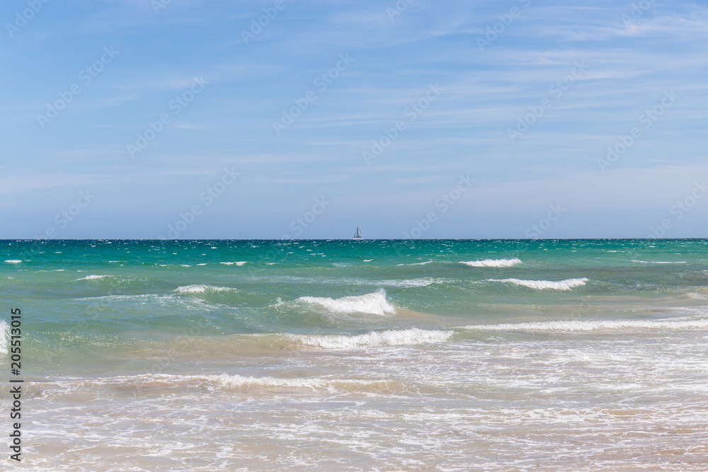 Sailing boat in the blue turquoise blue sea with wind waves in a sunny day Sailing boat in the blue turquoise blue sea with wind waves in a sunny day