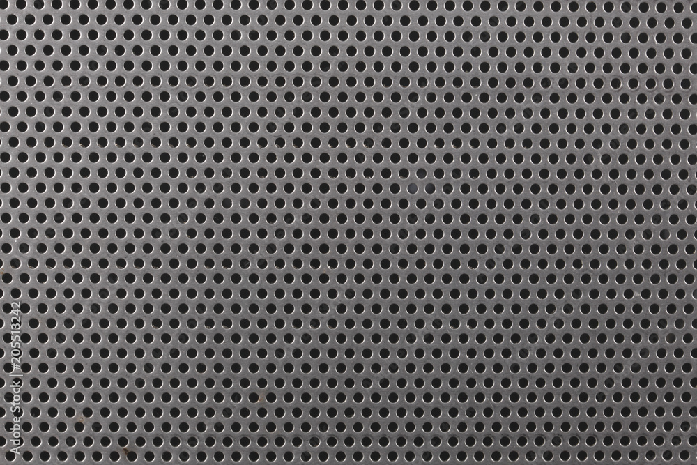 close up on a mettalic texture with small holes close up on a mettalic texture with small holes