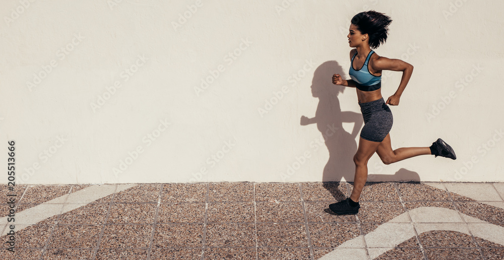 Healthy woman athlete running outdoors