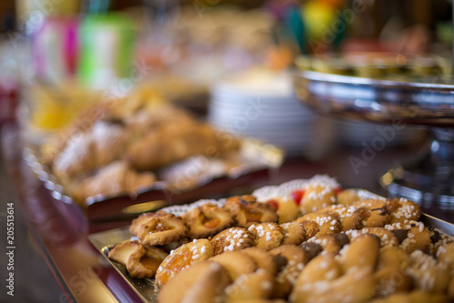 Blurred table with sweet breakfast. Close-up of a tray with cookies