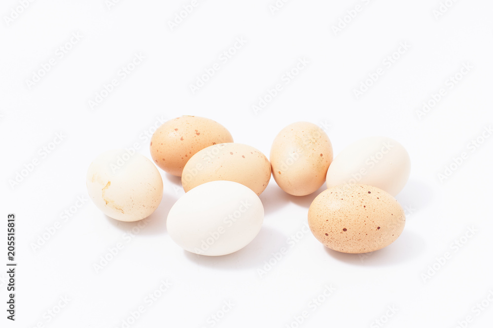 chicken eggs in a plastic container on a white background