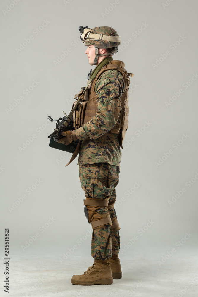 Soldier in camouflage holding rifle Soldier in camouflage holding rifle