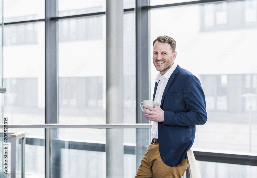 Portrait of smiling businessman having a coffee break Portrait of smiling businessman having a coffee break