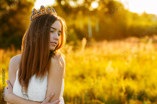 charming girl with a crown outdoors