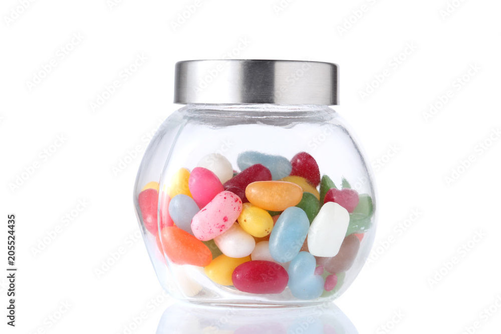 a glass jar half full of colored candies with isolated on white background with clipping path a glass jar half full of colored candies with isolated on white background with clipping path