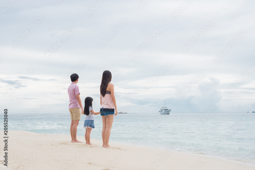 Happy young family having fun running on beach . Family traveling concept Happy young family having fun running on beach . Family traveling concept