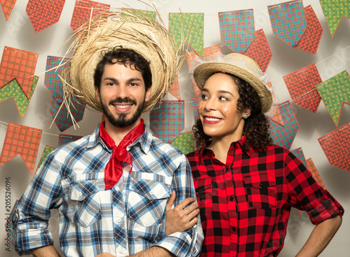 Festa Junina: party in Brazil. Man and woman dressing checked pattern clothes. Man and woman dressing checked pattern clothes are standing.