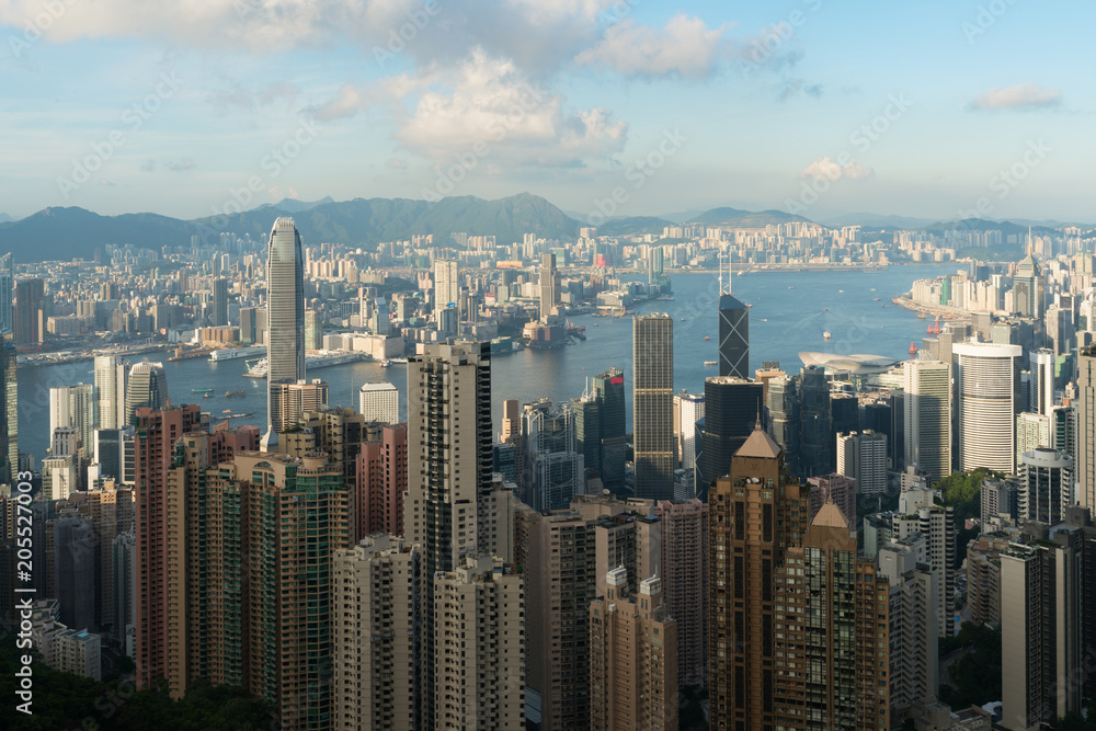 Aerial view of Hong Kong skyline and Victoria Harbor with blue sky in Hong Kong. Asia.. Aerial view of Hong Kong skyline and Victoria Harbor with blue sky in Hong Kong. Asia..