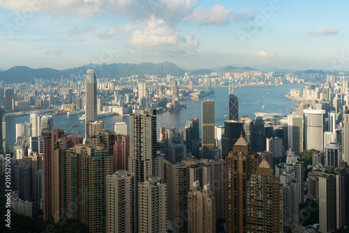 Aerial view of Hong Kong skyline and Victoria Harbor with blue sky in Hong Kong. Asia..