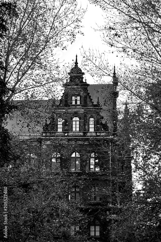 Creepy old house against the blue sky. Black and white