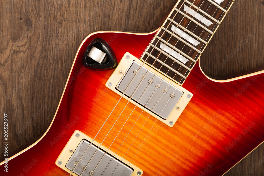 Old beautiful electric guitar on a background of wood. Old beautiful electric guitar on a background of wood.