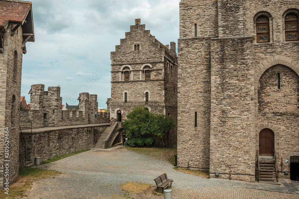 Fototapeta premium Stone watch-tower, walls and flags inside the Gravensteen Castle at Ghent. In addition to intense cultural life, the city is full of Gothic buildings and Flemish style architecture. Northern Belgium.