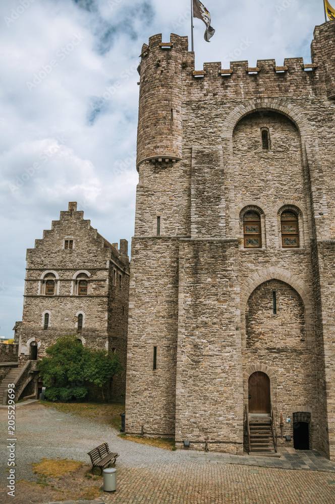 Stone watch-tower, walls and flags inside the Gravensteen Castle at Ghent. In addition to intense cultural life, the city is full of Gothic buildings and Flemish style architecture. Northern Belgium.