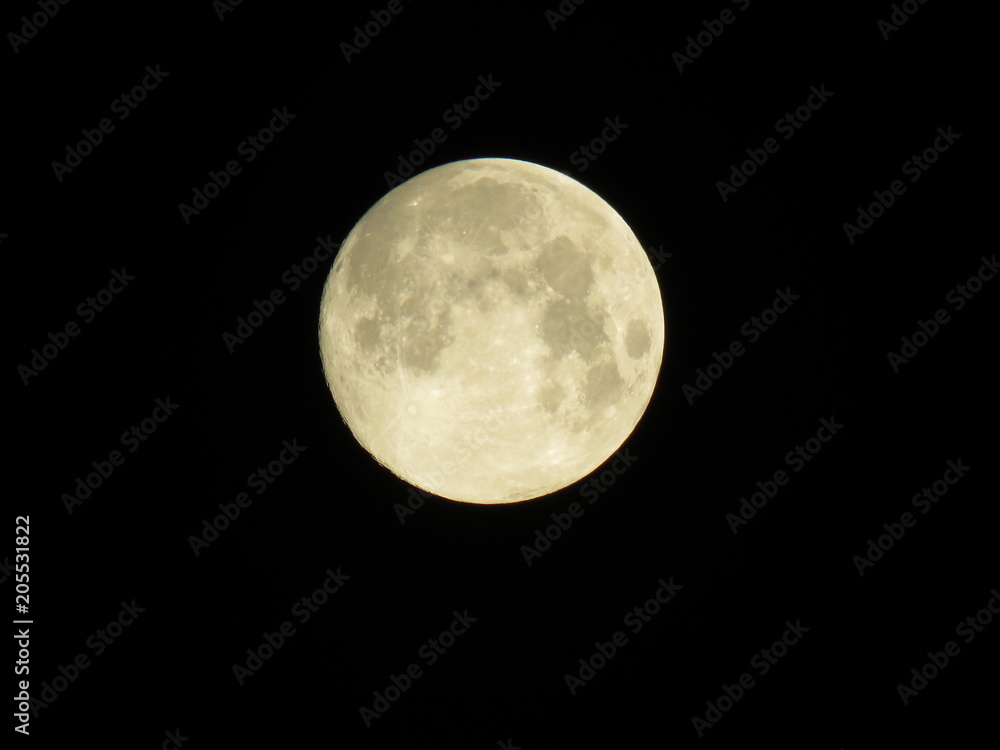 Isolated full moon with lunar craters, seas and mountains visible Isolated full moon with lunar craters, seas and mountains visible