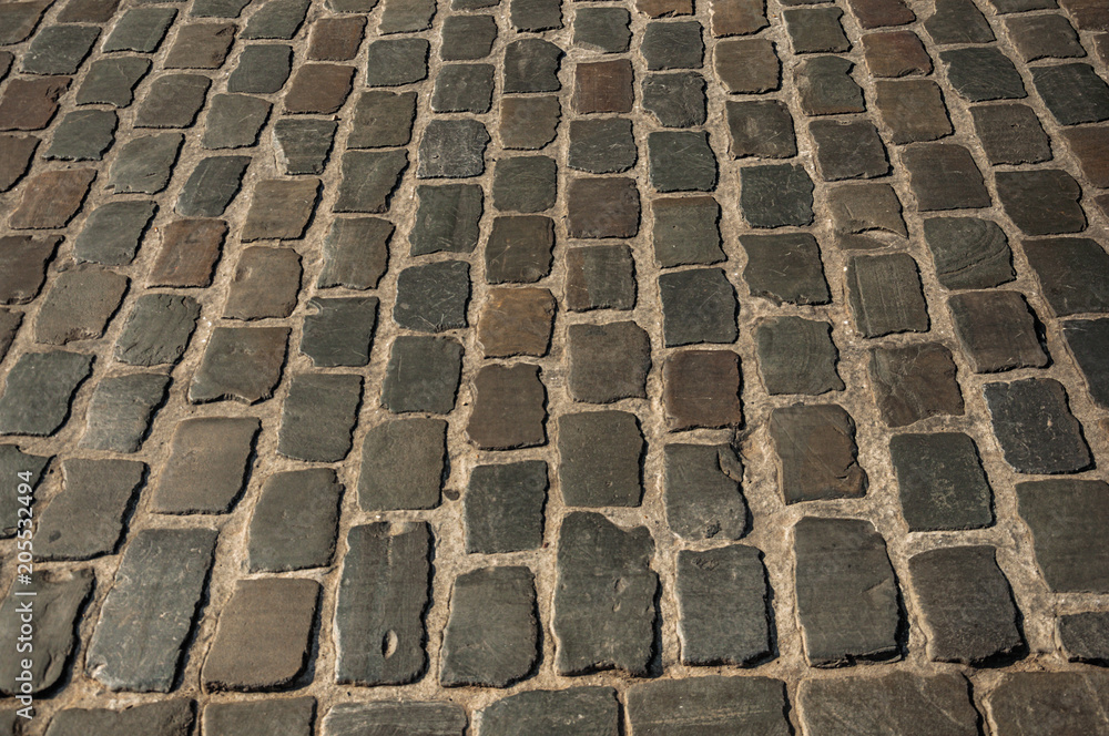 Fototapeta premium Close-up of stone sidewalk at sunset in the City Center of Ghent. In addition to intense cultural life, the city is full of Gothic and Flemish style buildings. Northern Belgium.