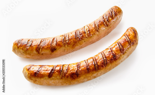 Close-up of two grilled German sausages on white