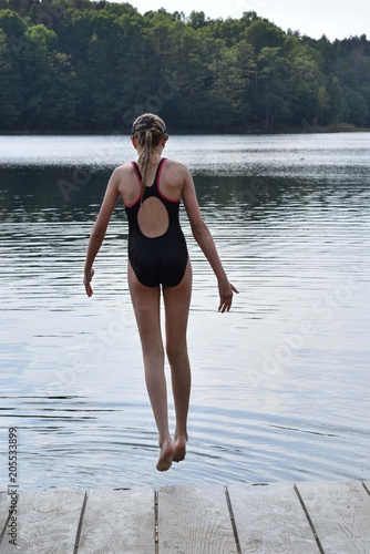 A young Slav girl jumping to the lake in a diving mask