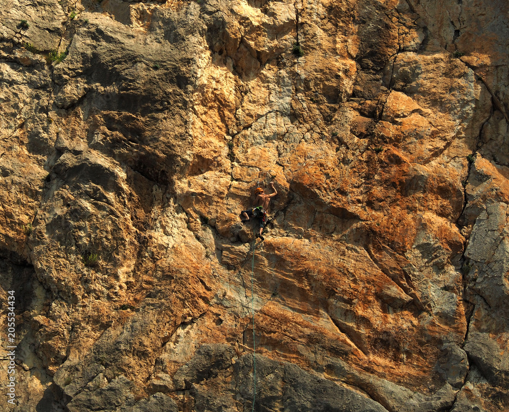 Rock climber resting during hard climb.